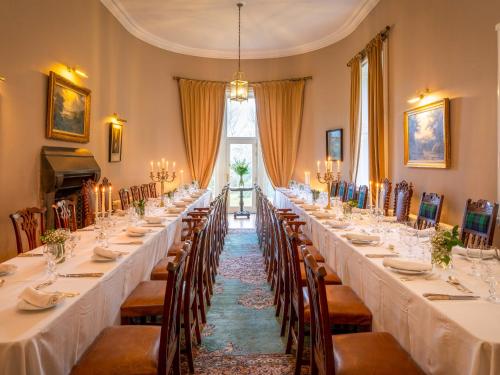 a row of long tables in a room with chairs at Dalnaglar Castle - Uk7072 in Cray