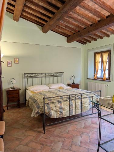 a bedroom with a bed and a wooden ceiling at Agriturismo Il Giovannello in Roccastrada