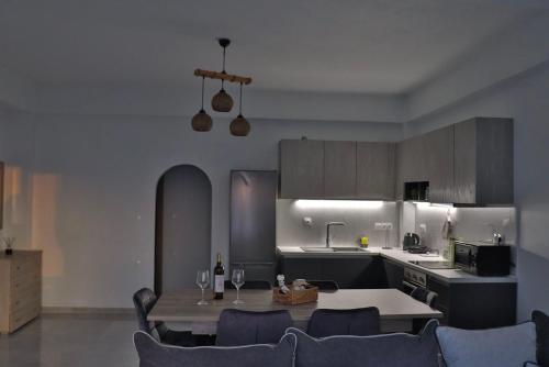 a kitchen with a table with wine glasses on it at Eagle's Nest Kythnos in Flampouria