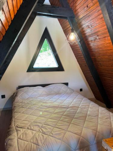 a bedroom with a large bed in a attic at Vila Mirra in Teslić
