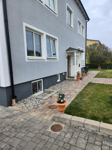 a gray house with plants in front of it at Prisvärt semesterboende in Vadstena