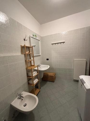 a bathroom with a sink and a toilet and a mirror at Appartamento Nicoletta in Portolo