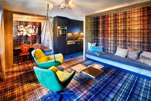 a living room with two chairs and a swing at HEART - Manufaktur Appartements in Sölden