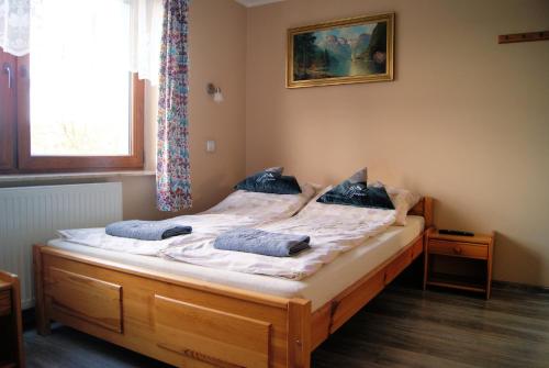 a bedroom with a bed with two pillows on it at U Jasia - Agroturystyka in Bańska Niżna