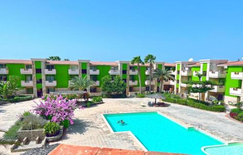 an apartment with a swimming pool in front of a building at InkHouse C02 in Santa Maria