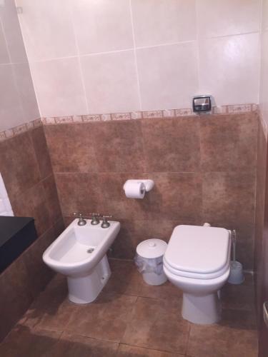 a bathroom with a toilet and a sink at Duplex del Sol in Villa Carlos Paz