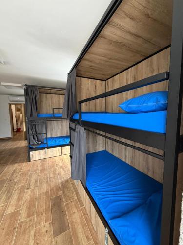 two bunk beds in a dorm room with blue pillows at Albergue Freixo in Palas de Rei