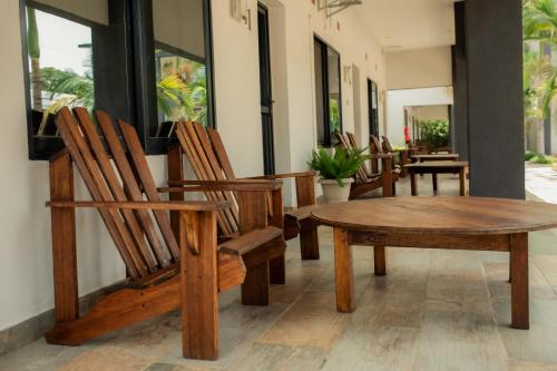 a group of chairs and a wooden table and bench at Chandamali Bed & Breakfast in Kitwe