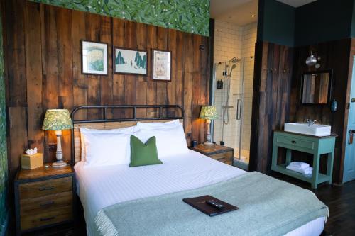 a bedroom with a bed with a tray on it at Hinds Head in Aldermaston