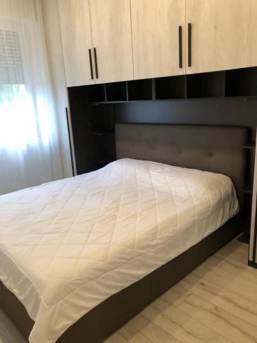 a bed in a bedroom with wooden cabinets at Residenza Thiene Centro in Thiene