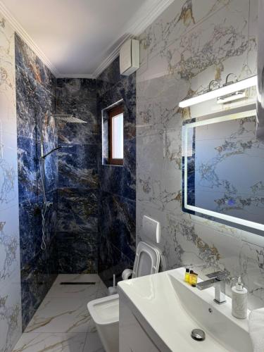 a bathroom with a sink and a toilet at Hotel Exclusive in Tirana