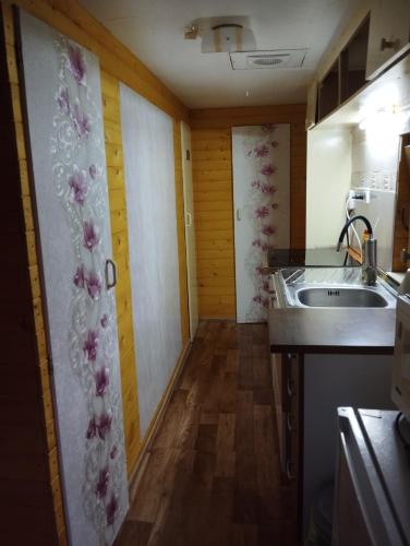a small kitchen with a sink and a counter top at Domček pri vode Pohoda in Teplý Vrch