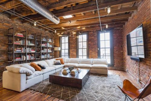 a living room with a couch and a coffee table at The Library-Downtown Nashville Luxury Penthouse Printers Alley Steps to Broadway in Nashville