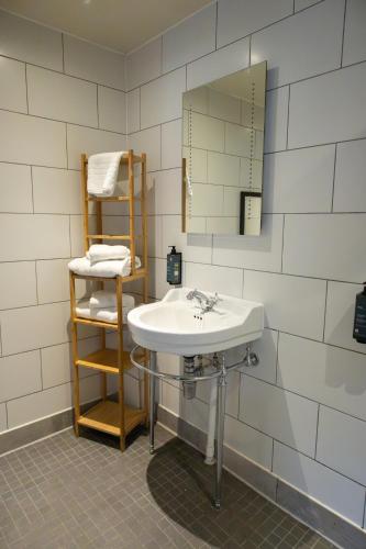 a bathroom with a sink and a mirror at Hinds Head in Aldermaston