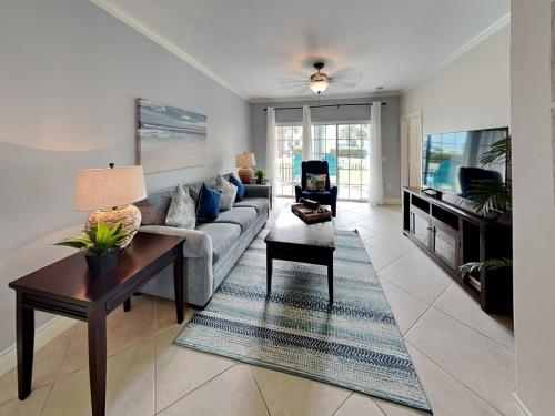 a living room with a couch and a table at Dawn 315-saltwater Escape in Galveston