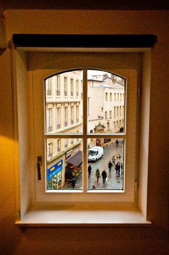 a window with a view of a city street at Loft Le Saint Louis by La Chambre à Coté in Metz