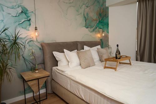 a bedroom with a large bed with a table at BlackBird Hub in Arad
