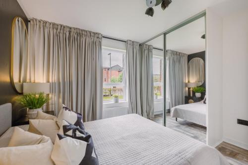 a bedroom with a bed and a large window at SmartSleep Apartments in Glasgow