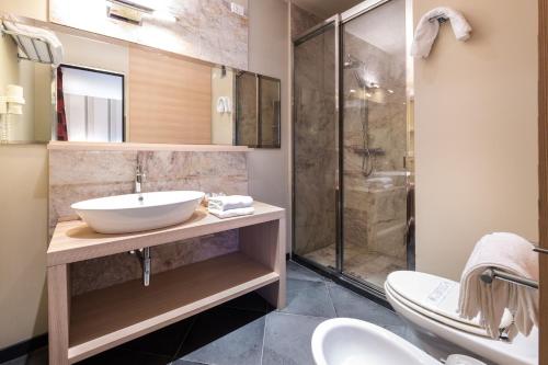 a bathroom with a sink and a shower at El Homs Palace Hotel in Comiso