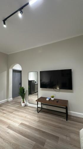 a living room with a large flat screen tv at شقق مخدومة in Jazan