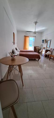 a living room with a bed and a table and chairs at Smalis Studios in Lakkíon