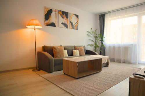 a living room with a couch and a coffee table at LZR Apartments in Braşov