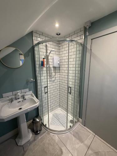 a bathroom with a shower and a sink at The Hilltop Hideaway in Enniskillen