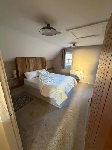 a bedroom with a bed and a window at The Hilltop Hideaway in Enniskillen