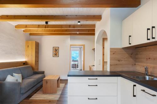 a kitchen and living room with a couch at Residence Sonngart in Lagundo