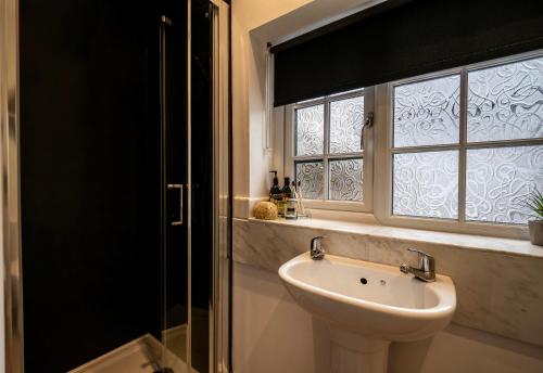 a bathroom with a sink and a window at Greenacres in Kelsale