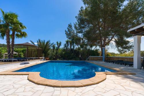 a swimming pool in the middle of a yard with trees at Asteria Eco Finca Sustainable 6 Bedroom Nature Retreat near UNVRS Ibiza in Santa Gertrudis de Fruitera