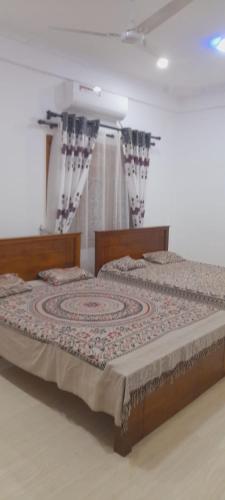 a bedroom with a bed with a rug on it at Europenvilla in Mannar