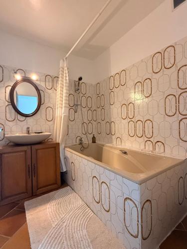 a bathroom with a large tub and a sink at Au bord de l eau in Villabé