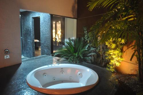 a bath tub sitting on a counter in a bathroom at Palace Motel (Adult Only) in Fortaleza