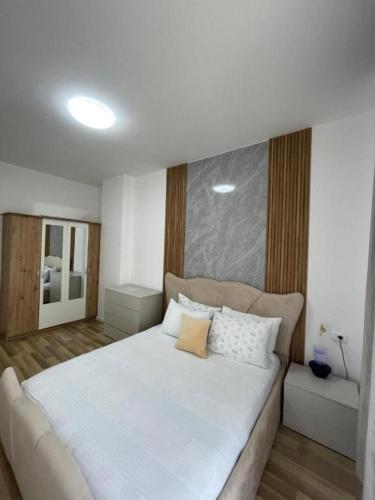a bedroom with a large white bed with two pillows at Enea Apartments 9 in Tirana