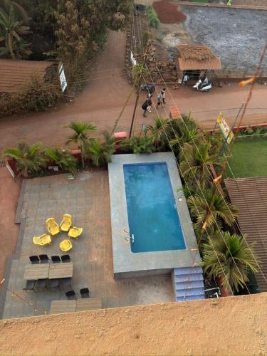 an overhead view of a swimming pool with lounge chairs at Shrileela Beach Resort in Murūd