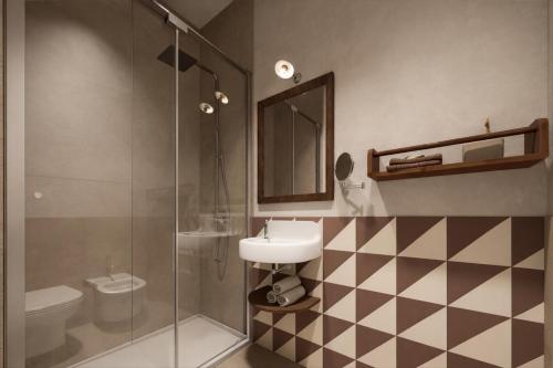 a bathroom with a sink and a glass shower at BYPILLOW Del Presto in Florence