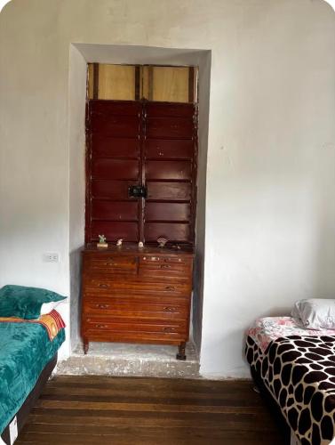 a room with a large wooden door with a bed at Tarmeñita VIP in Tarma