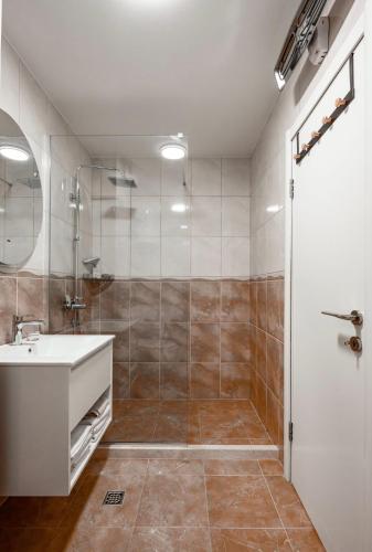 a bathroom with a sink and a shower at Aurea Tivat Apartment in Tivat