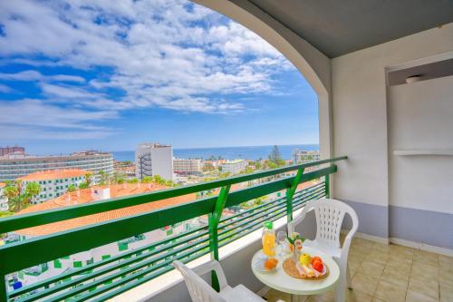 a balcony with a table and chairs and a view at RT-Green Park in Playa del Ingles