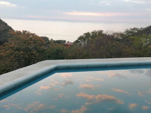 a swimming pool with a view of the sky at Macondo GuestHouse Beach in Playa Estacahuite