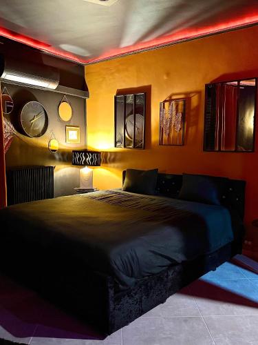 a bedroom with a large black bed in a room at LA LOVEROOM by Sunnyroom in Perpignan