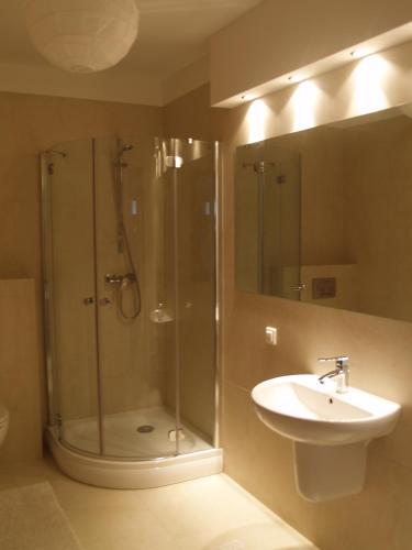 a bathroom with a shower and a sink at Wechta - Promenada Gwiazd 28 with Sea View, Free Rooftop Pool & Sauna in Międzyzdroje