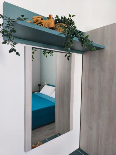a room with a mirror with a bed in it at B&B Casa Lina in Sarroch