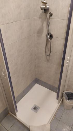 a shower with a glass door with a shower at Affittacamere Da Priscilla in Porto Torres