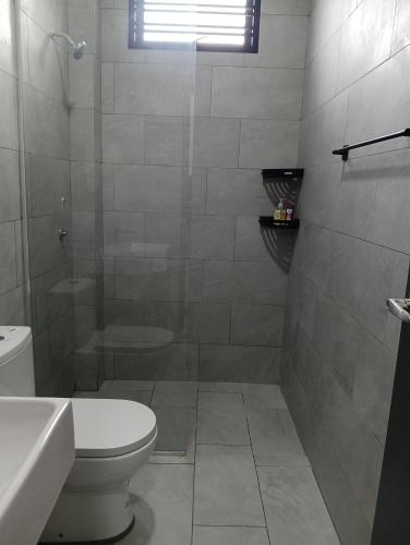 a bathroom with a shower and a toilet and a sink at HOMESTAY IMPIAN AYER MOLEK MUSLYM only in Malacca