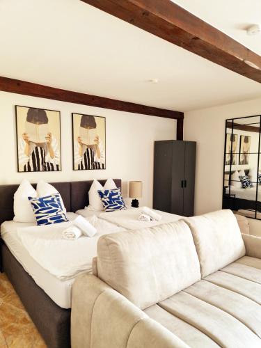 a bedroom with two beds and a couch at ARGENTA Living 42 in Künzell