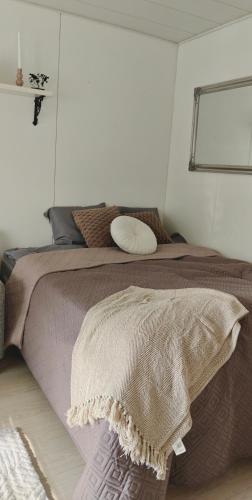 a bedroom with a bed with a blanket on it at Sorvarinraitin sydän in Seinäjoki
