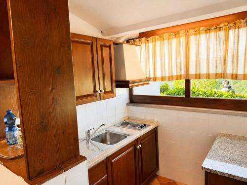 a small kitchen with a sink and a window at I Cancelli -Mugello Park Family Village in Palazzuolo sul Senio