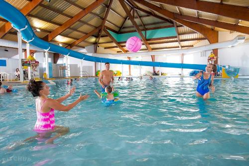 a group of people in a swimming pool at Taylor Tides Caravan in Abergele